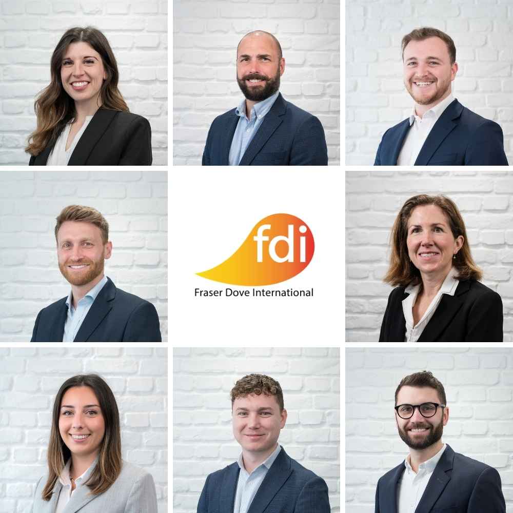 Fraser Dove International team members arranged around the Fraser Dove logo